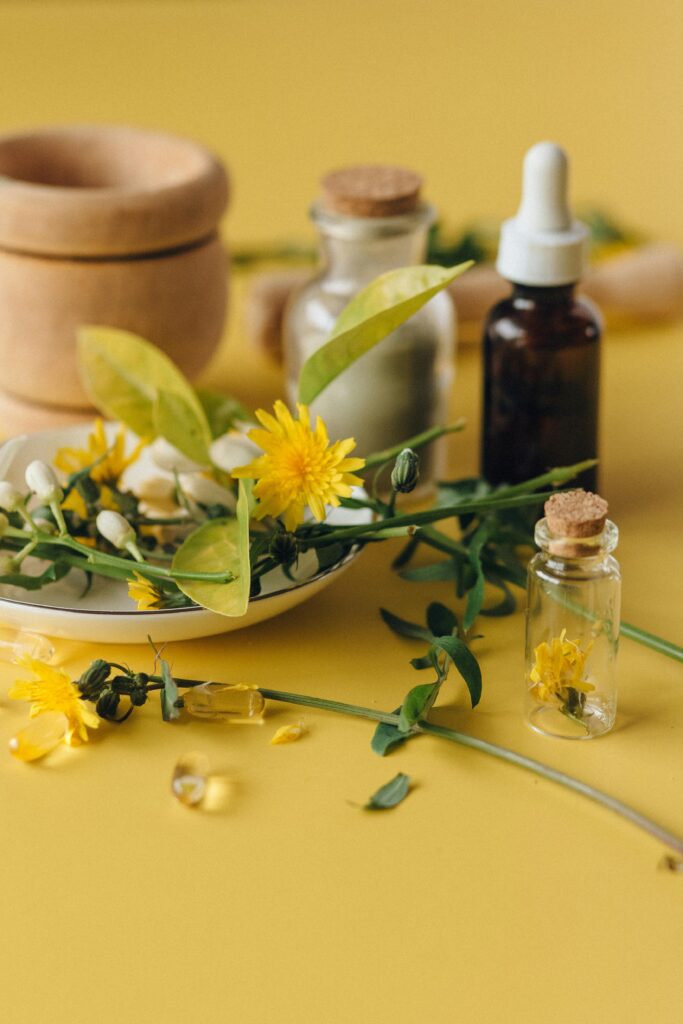 pexels-photo-7526013-7526013 Dried herbs and essential oils on a yellow background, perfect for natural health concepts.