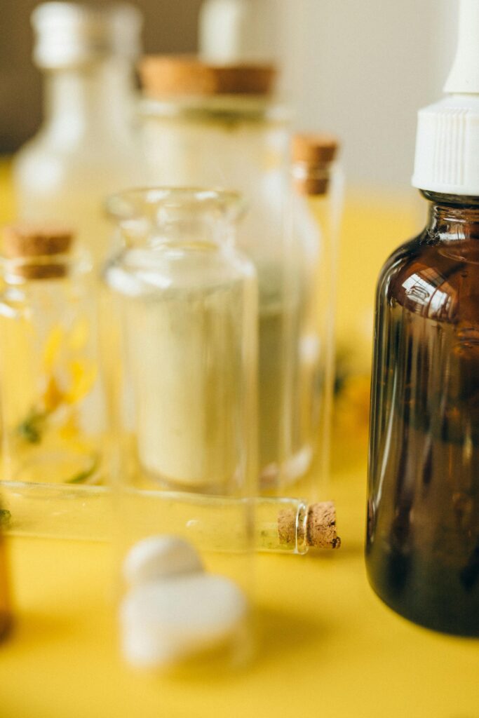pexels-photo-7526073-7526073 Various glass bottles and tablets on a bright yellow background, highlighting alternative medicine.